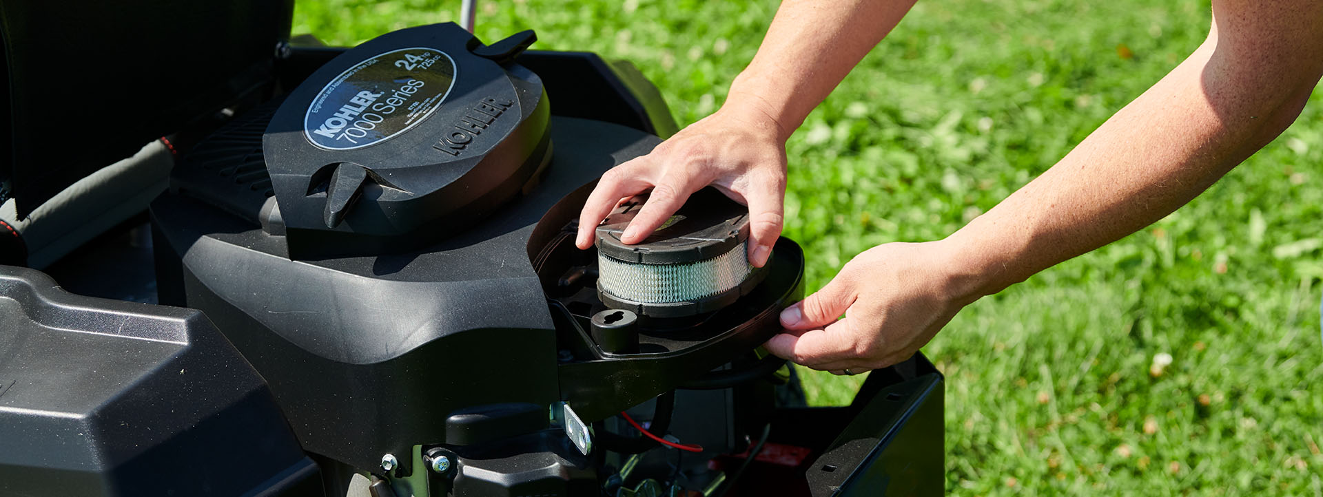 Lawnmower Maintenance Week - Person changing a filter in a mower