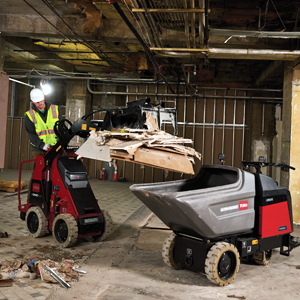 eDingo 500 with a grapple bucket unloading into the electric ultra buggy