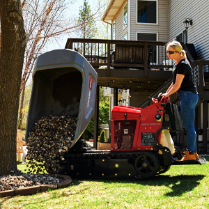 Swivel Ultra Buggy dumping rock around a tree trunk